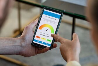 Married couple checking credit score online on phone app