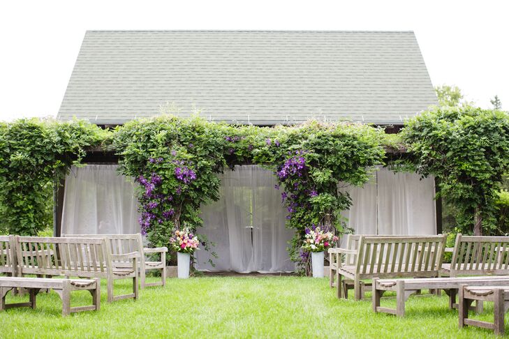 After visiting the venue in late fall and again in early spring, the bride was still surprised on the day of the wedding. "I was pleasantly surprised on the day we showed up to decorate that a purple Clematis 'Jackmanii' was in full bloom right at our altar," Lisa says.