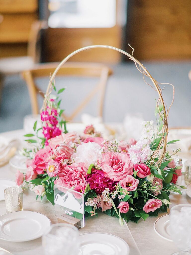 modern small wedding centerpiece with gold hoop, pink flowers and greenery