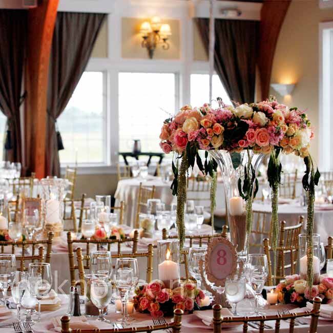 The tables were decorated with high and low arrangements with candles and roses. Sand in the vases nodded to the beachside setting in a subtle way.