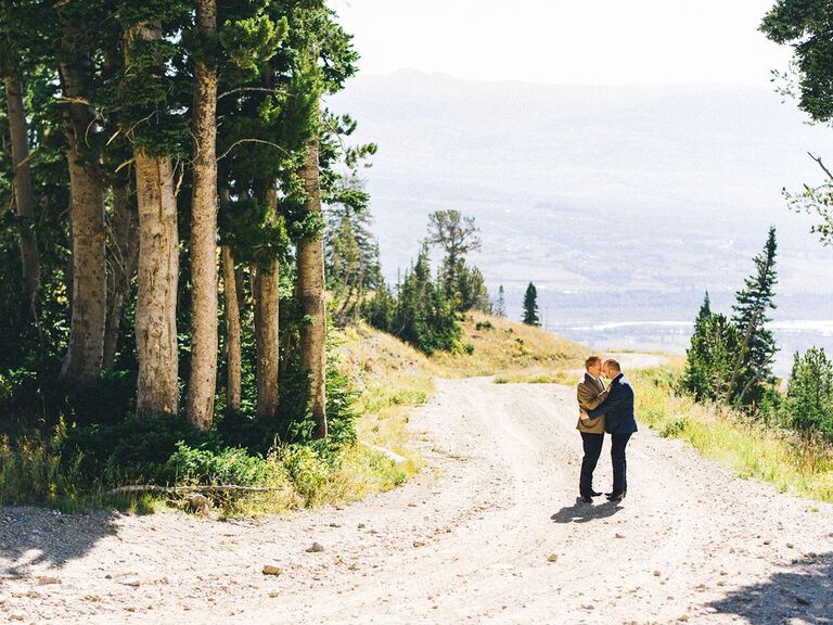 groom and groom kissing on mountaintop