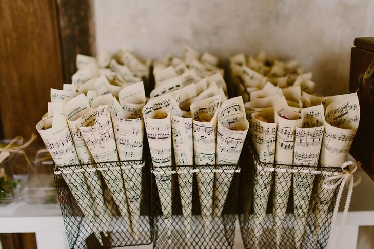 Sheet music was rolled up and contained dried flower petals that Chris's mother had collected months before the wedding. The petals were tossed by guests when the married couple exited the ceremony.