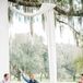 Ivory Fabric Wedding Arch Over Oak Tree