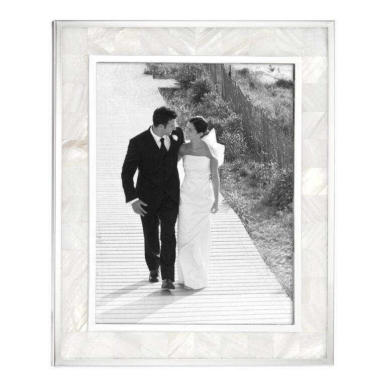 Elegant mother of pearl picture frame displaying a photograph of the newlyweds. 
