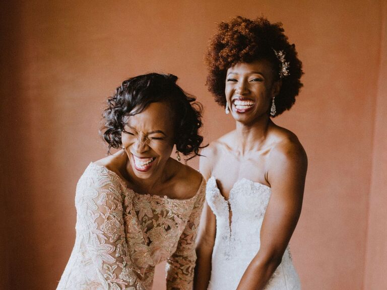 Mother and bride wear their hair in glamorous curls while laughing. 