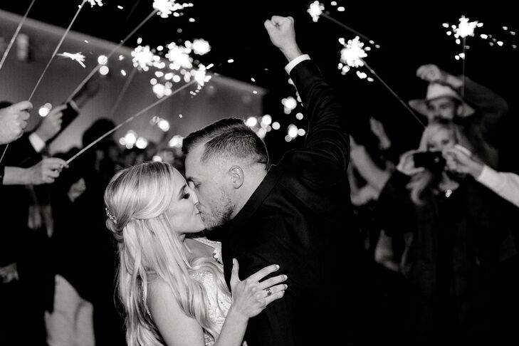 Bride and Groom Kissing During Classic Sparkler Exit