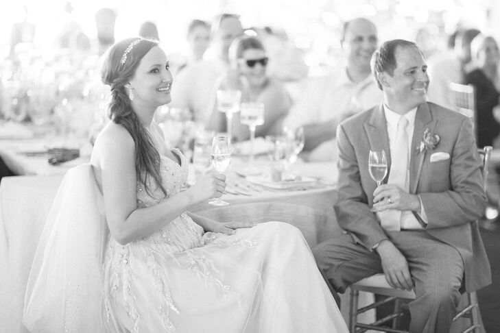 Wanting a soft and natural look, she worked with Tricia H. Gulikers Professional Hair & Makeup and picked out a side-swept ponytail. The wedding hairstyle was filled with casual, beachy waves that were made more elegant by her crystal-accented headband.