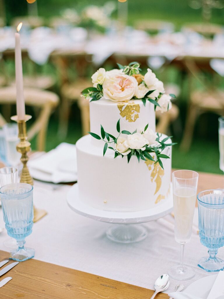 two tier smooth buttercream cake with edible gold leaf and blush roses