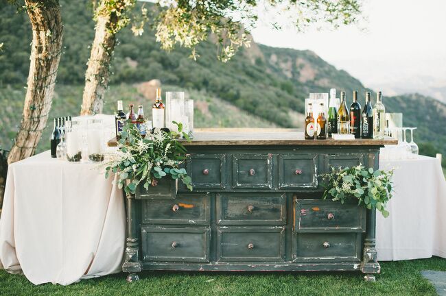 “I had to make the bar area a special highlight because Brendon loves and appreciates beer and whiskey a great deal,” Sarah says. The pair found a dresser at Found Vintage Rentals and knew they had to incorporate it into their bar. The pair served a selection of their favorite beers, including Samuel Smith's Pale Ale and Bass, as well as several varieties of Saddlerock’s own wines. Honey & Poppies filled the drawers with eucalyptus and white wildflowers.