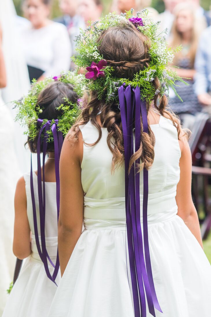 Flower girls wore floral headpieces with purple ribbon attached at the back down the ceremony aisle.