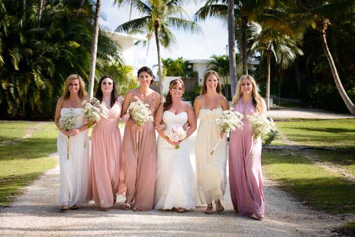 The bridesmaids wore different styled dresses in shades of cream and pink. Each carried a bouquet of baby’s breath.