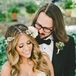 Marisa wore an elegant silver necklace that rested right above her ivory lace sweetheart neckline, adding a nice touch to her romantic look. Marisa wore her hair in a wavy down style, with pastel-colored blooms woven into the sides.