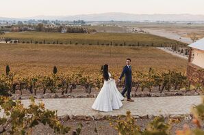 Bride in White Ivory Lehenga, Groom in Navy Suit Walking Through Vineyard, Indian Wedding