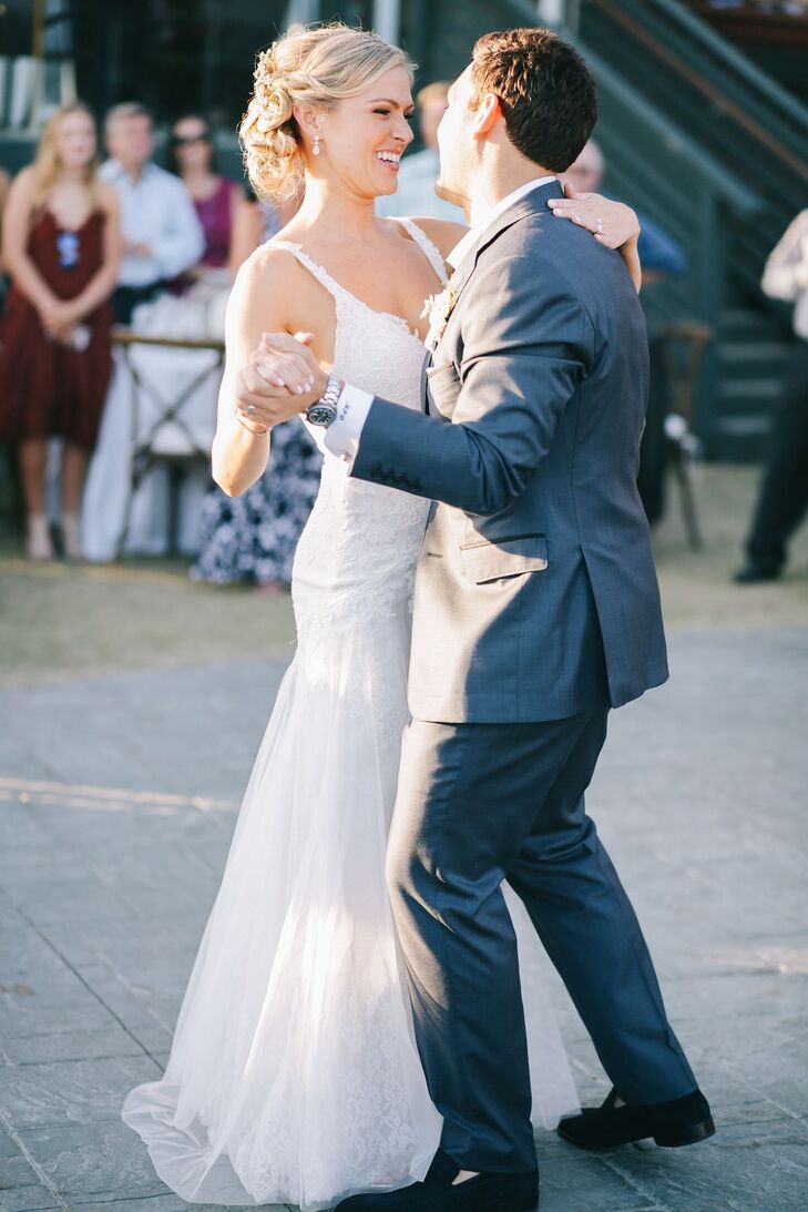 "My Alvina Valenta gown was made of ivory English net over champagne charmeuse with French Alencon lace throughout," Leah says. "The shape was a slim-fitting A-line with a deep V-neck, low-back and jeweled ribbon at the natural waist. I loved how it felt soft, flowing and elegant—perfect for our beach wedding."