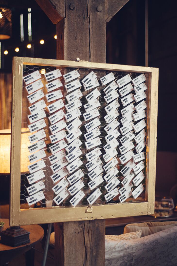 Who knew an old-school label maker could do this? Erin and Cory's 170 guests found their names embossed on a black-and-white label and attached to simple white escort cards as they entered the barn reception. For a fun twist, the cards were either hung on a repurposed, gold window pane or placed on a shabby-chic table surrounded by succulents.