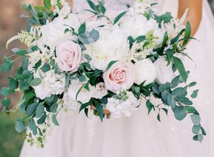 Lauren and Kaleb's wedding at Canyonwood Ranch in Dripping Springs, Texas, was all about dreamy blush tones, lush greenery-filled floral arrangements 