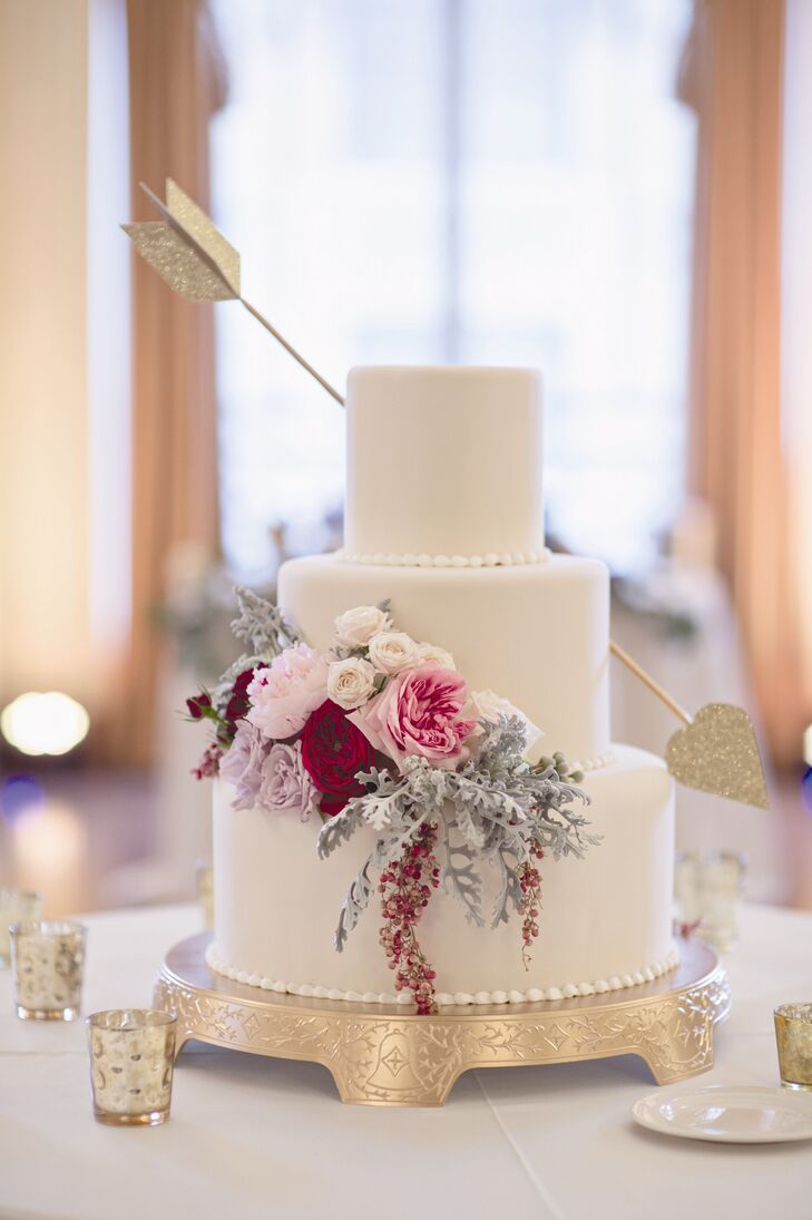 Instead of a topper, the baker placed a gold arrow through two of the wedding cake tiers -- a subtle nod to the Valentine's Day wedding date.