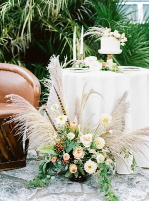 Cake Table with Arrangement of Pampas Grass, Dahlias, Feathers, Peonies and GReenery