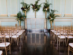 Modern Ceremony Site with Gold Chairs and Tropical Leaves