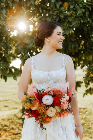 Bride With Low Bun and Vibrant, Warm-Tone Bouquet at Desert Wedding