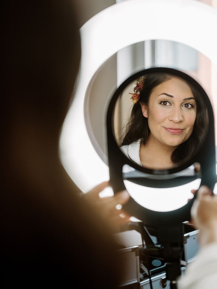 A Bride Getting Ready and Admiring Herself in a Hand Mirror