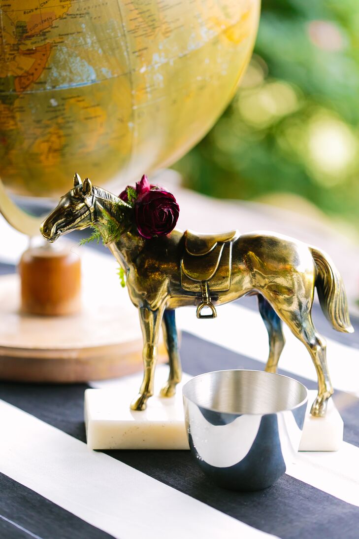 Paige's true passion are her horses: She's been riding and showing horses for most of her life, so her wedding wouldn't have been her style without lots of equine touches. She incorporated lots of vintage horse figurines, ribbons and saddles in her decor to showcase her favorite hobby. (We love how this horse figurine is even wearing a mini floral wreath.)