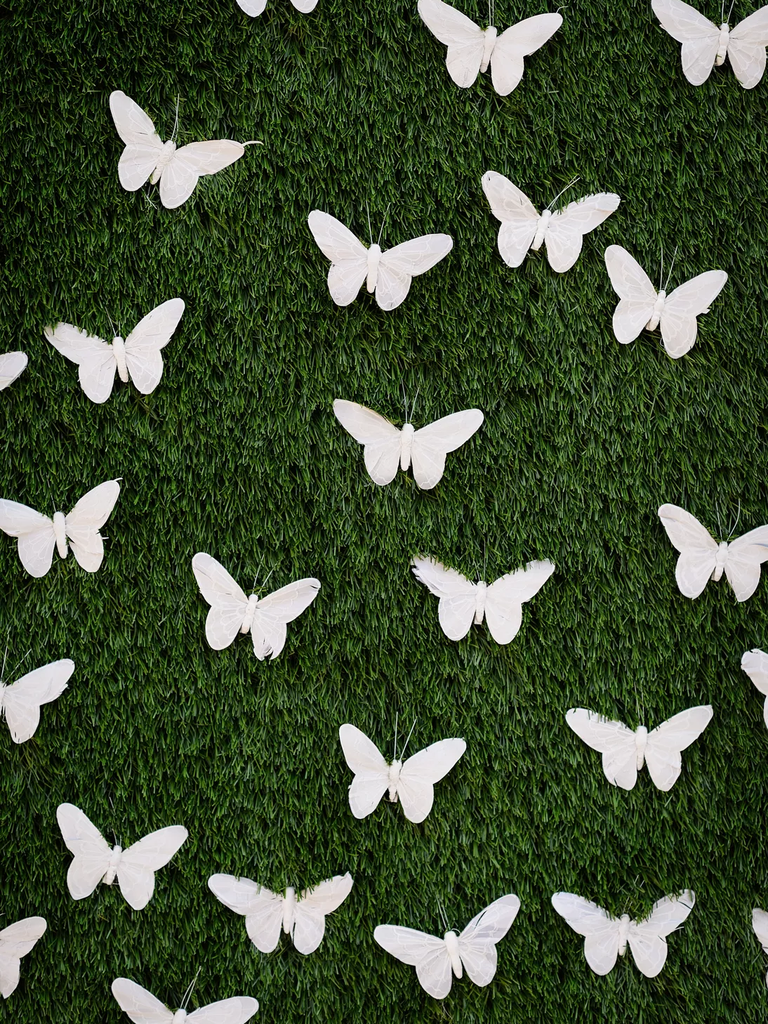 Greenery Backdrop With White Butterfly Decorations