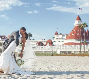 bride and groom kissing on the beach