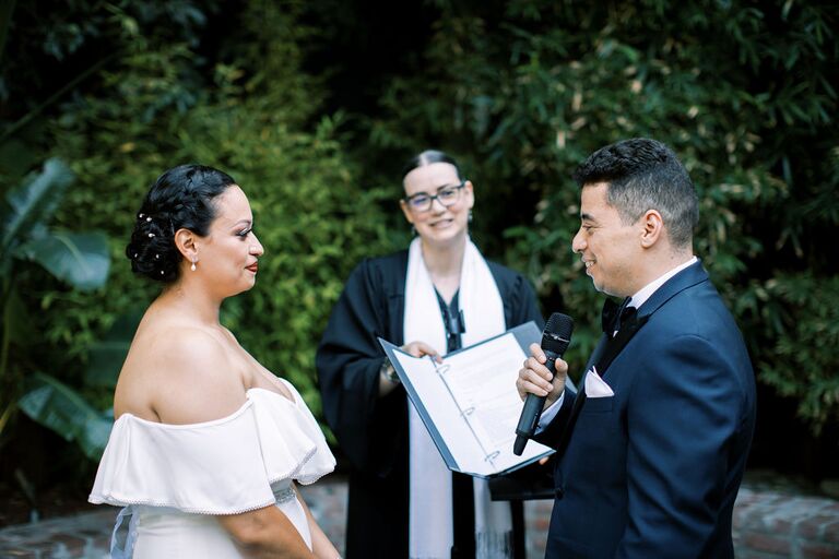 couple exchanging vows in front of wedding officiant
