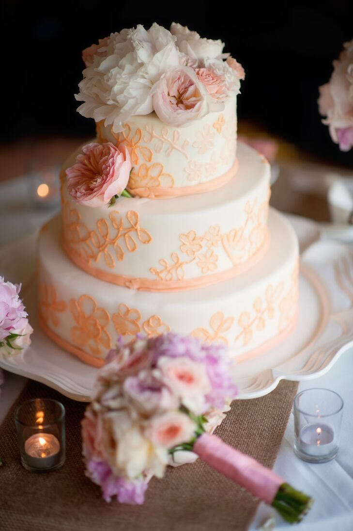The blush  piping on Nellie and Chris's buttercream wedding cake was designed to mimic the lace from her reception dress.