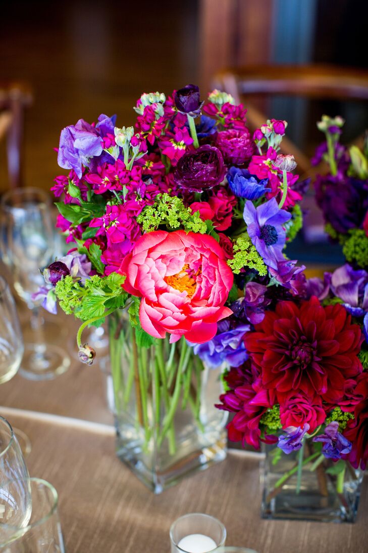 Large colorful centerpieces filled with ranunculuses, anemones, tulips, garden roses and stock decorated some of the tables.