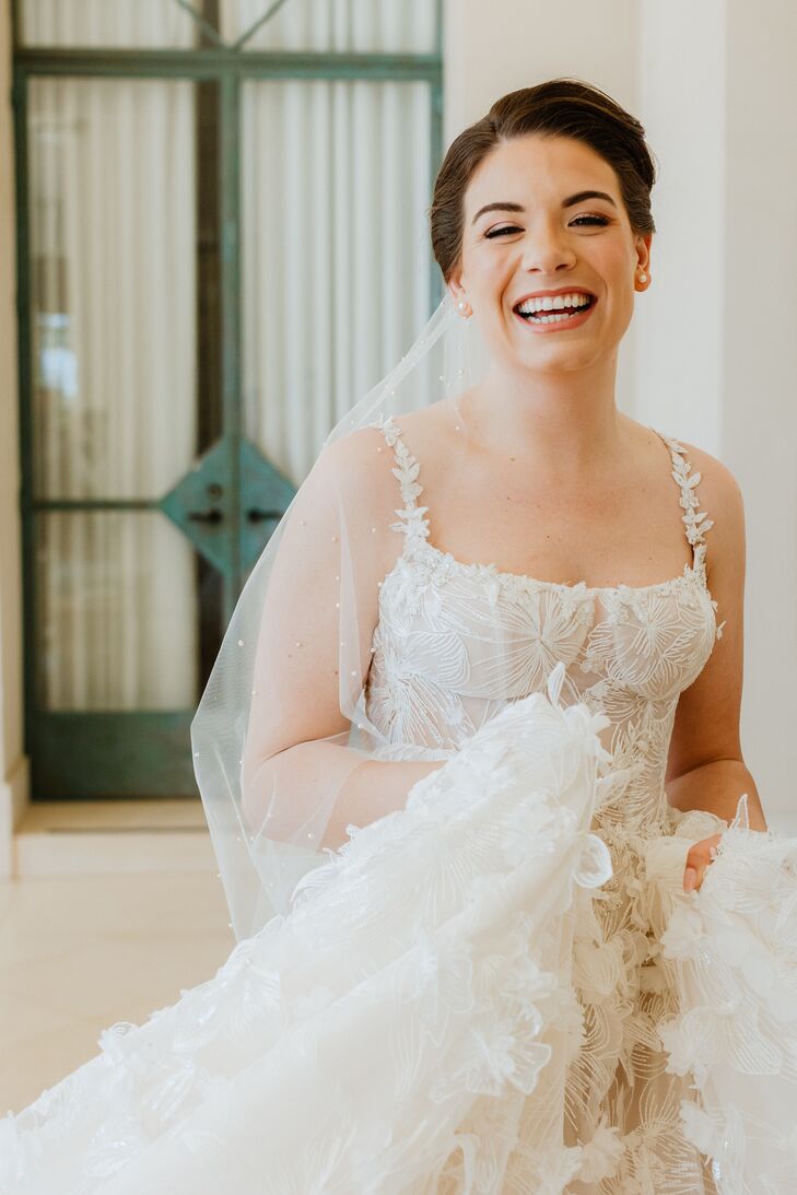 Bride in Designer Gown With 3-D Flowers and Long Veil