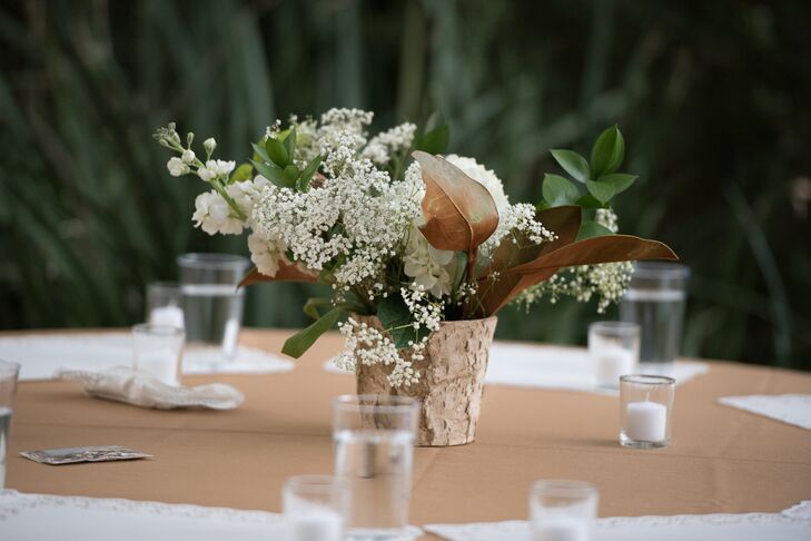 Olivia purchased wholesale flowers, and her father found wildflowers to mix in to create their rustic, textured centerpieces.