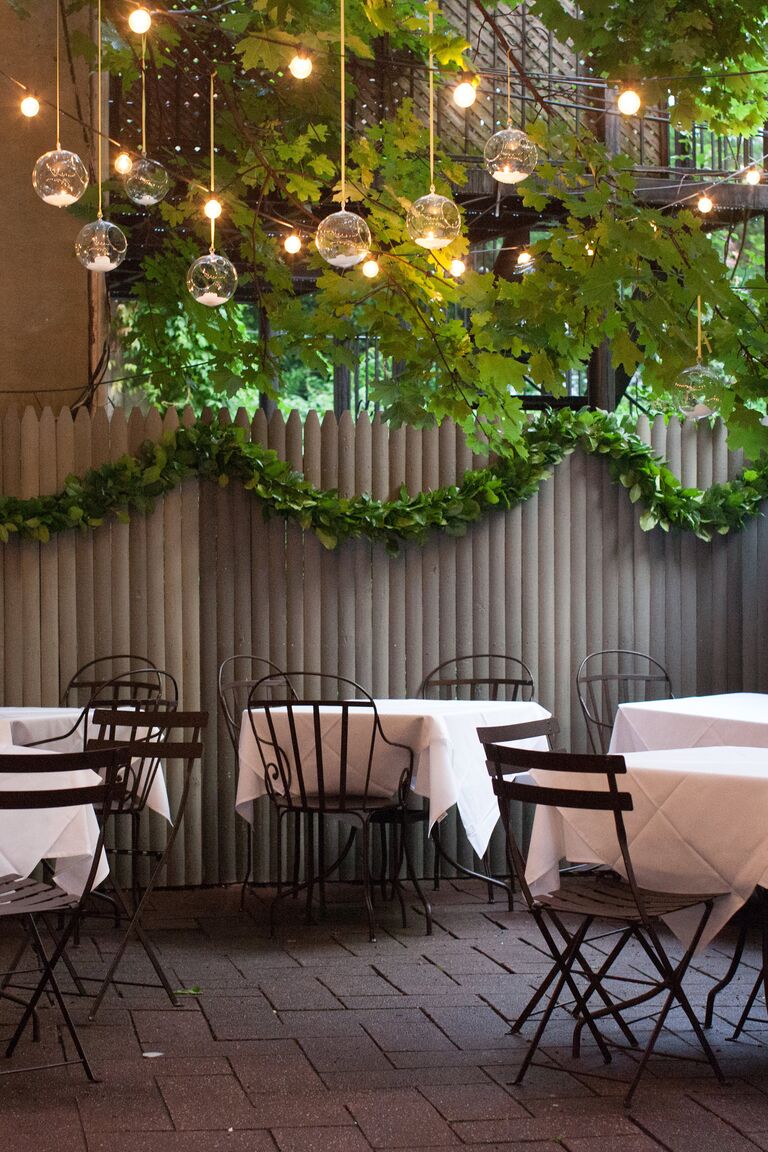 Simple reception decor with green leaf garlands