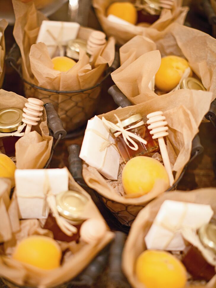 French wired baskets filled with fresh apricots, honey and local cheddar cheese wrapped in butcher paper was offered to guests as favors.