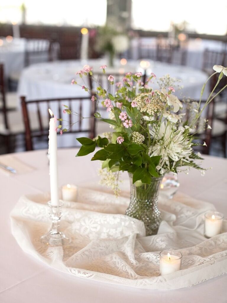 A delicate and lovely centerpiece of wildflowers and greenery.
