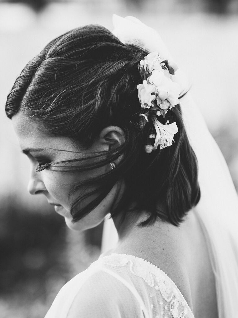 wedding hair flowers braided half up with flowers one one side