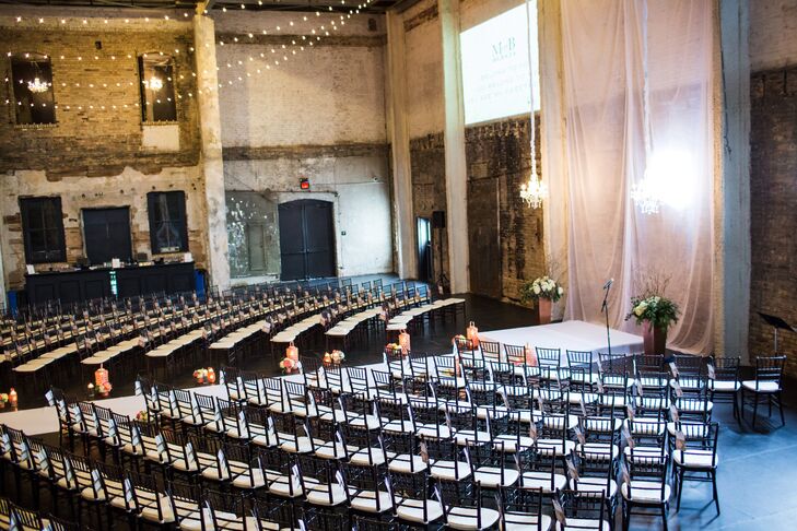 Molly and Boston had their ceremony at Aria in Minneapolis, Minnesota. The chairs were set up in a semicircle around the altar so everyone could see the couple exchange vows. A long drape behind the altar ran down the full length of the aisle to double as a backdrop and runner.