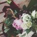 Justine carried a bouquet with pink and white peonies, white roses, white stock flowers and greens. her bouquet was wrapped with burgundy velvet ribbon.