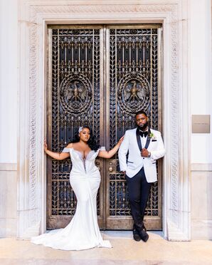 Bride in Elegant, Fitted Off-the-Shoulder Gown With Deep V Neckline and Groom in Sophisticated White-and-Black Tuxedo