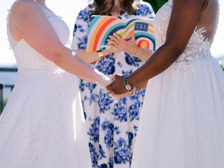couple holding hands exchanging marriage vows