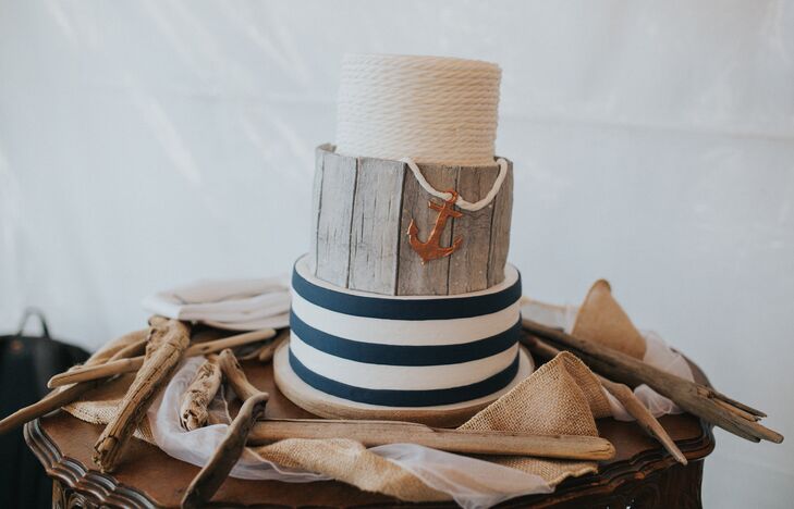 The three-tier cake featured navy and white nautical stripes, a middle layer resembling weathered wood and an anchor.