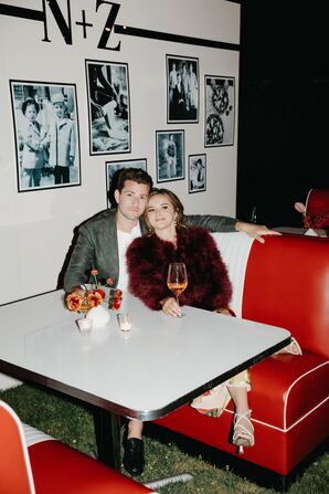 Bride and Groom Sitting in Diner Booth at Rehearsal Dinner