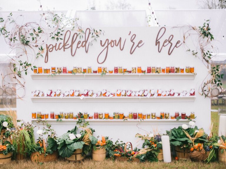 Wedding favor wall with jars of pickles