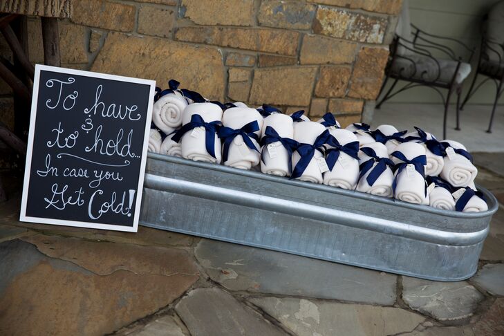 Since Leigh and Westin got married in the winter, they gave their guests blankets for favors. “They made a nice touch of decoration with navy bows, and a little tag said our names, wedding date and ‘Love Keeps Us Warm.’”