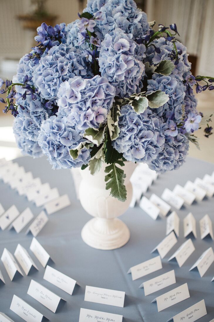 Guests found their seating arrangement in a pretty circular display around a floral centerpiece.