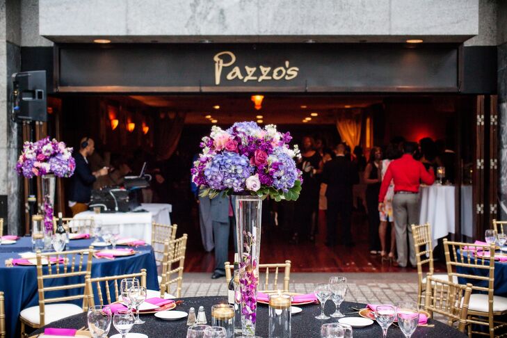 Dramatic centerpieces featured glass vases filled with signature orchids and topped with lush purple, fuchsia and pink blooms.