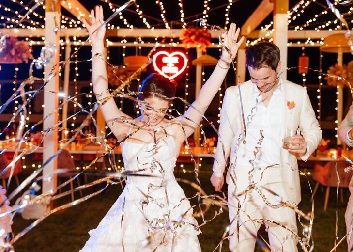 Bride and Groom Grand Exit Under String Lights Amongst String Confetti
