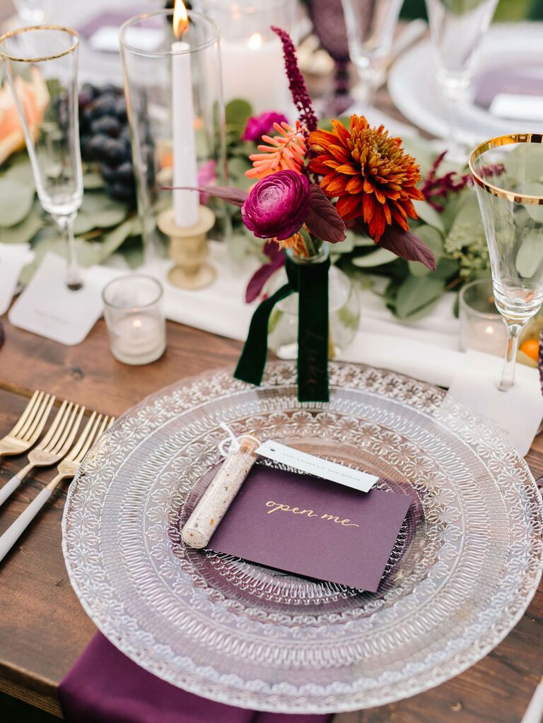 Vintage wedding reception tablescape with textured charger and gold-rimmed glasses