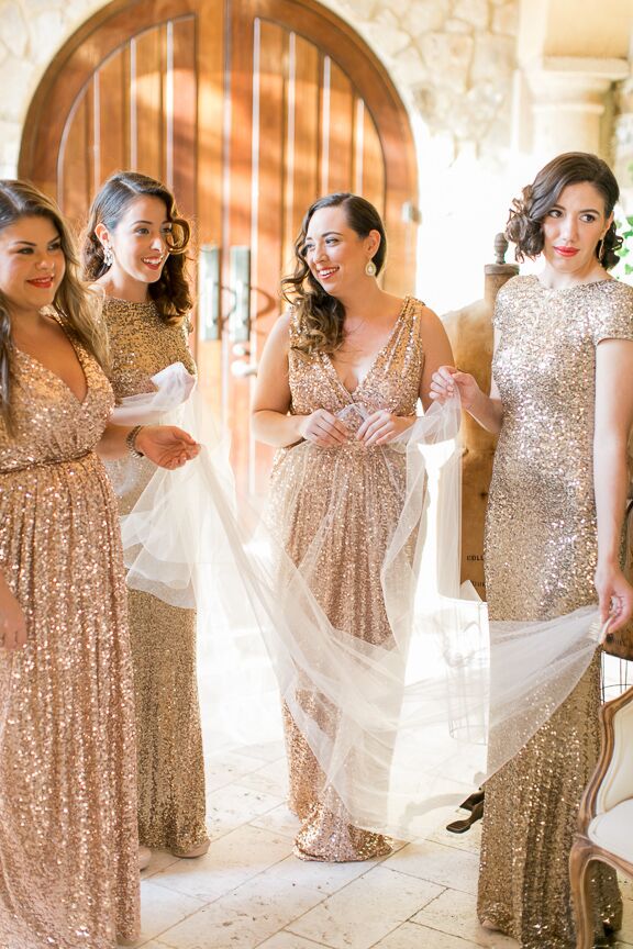 The bridesmaids wore gold and rose gold sequin Badgley Mischka sequin dresses for an added vintage feel. “I chose different styles to accommodate the different body types,” says Michelle. “I wanted them to look very glamorous.”